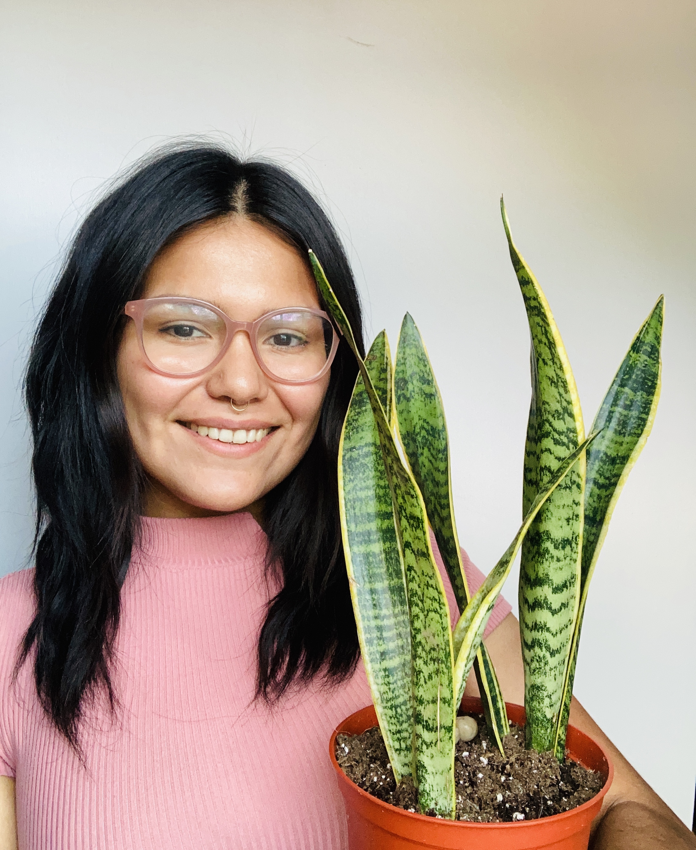 Araceli Carmona posing with one of her plants